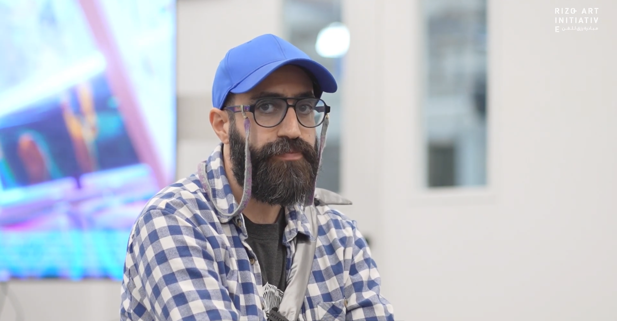 Portrait of Mohsen Hazrati wearing glasses and a blue cap