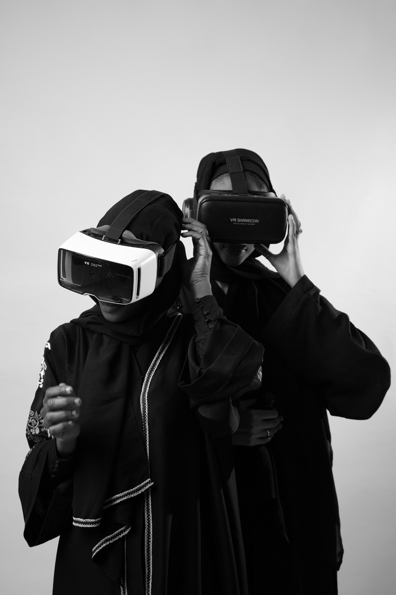 Two people wearing virtual reality headsets